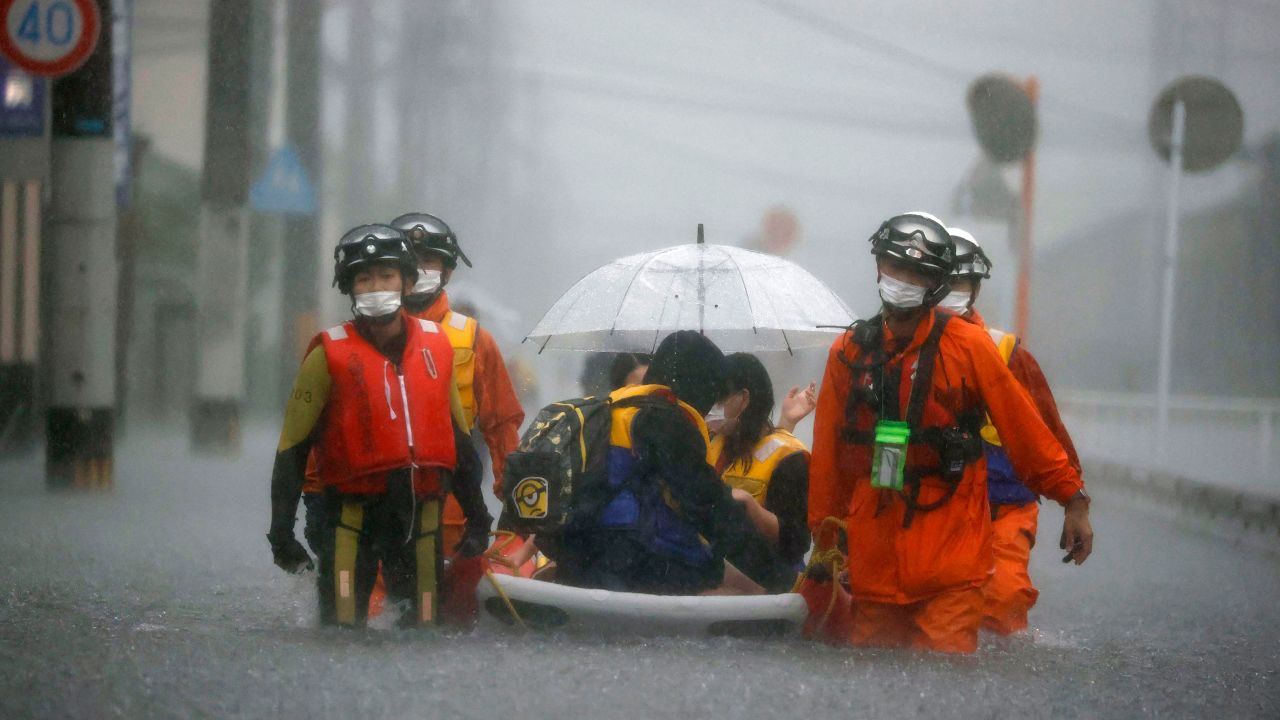 Firefighters rescue stranded residents on a boat in Kurume, Fukuoka, Japan, on August 14.