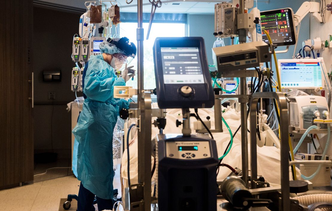 Nichole Arevalo, an R.N. at the downtown campus of NCH in Naples, Florida, treats a Covid-19 patient in the Intensive Care Unit on August 9, 2021. 