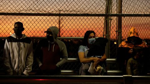 Migrants in the "Remain in Mexico" program queue at the Paso del Norte border bridge to reschedule their immigration hearings amid the coronavirus disease outbreak, in Ciudad Juarez, Mexico April 21, 2020.