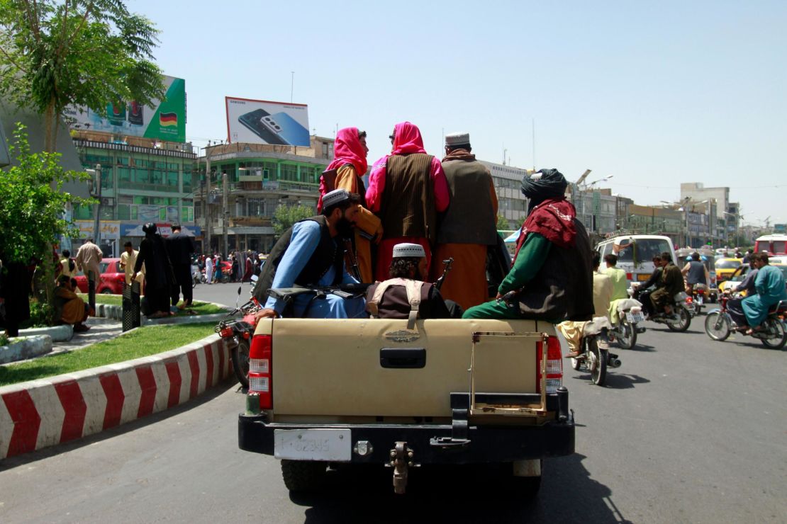 Taliban fighters sit on the back of a vehicle in the city of Herat, west of Kabul on Saturday. 