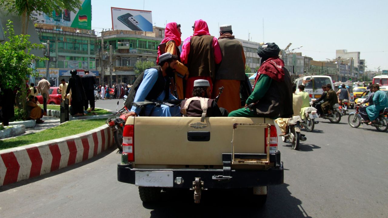Taliban fighters sit on the back of a vehicle in the city of Herat, west of Kabul on Saturday.