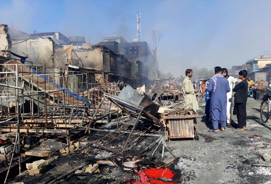 Afghans in Kunduz inspect damaged shops after fighting between Taliban and Afghan security forces on Sunday. 