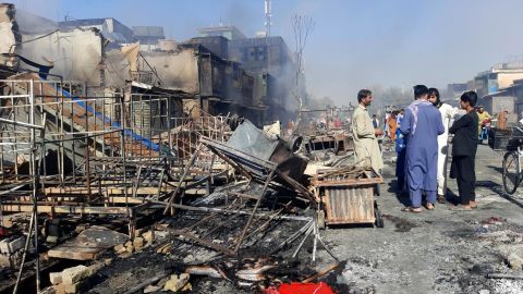Afghans in Kunduz inspect damaged shops after fighting between Taliban and Afghan security forces on Sunday. 