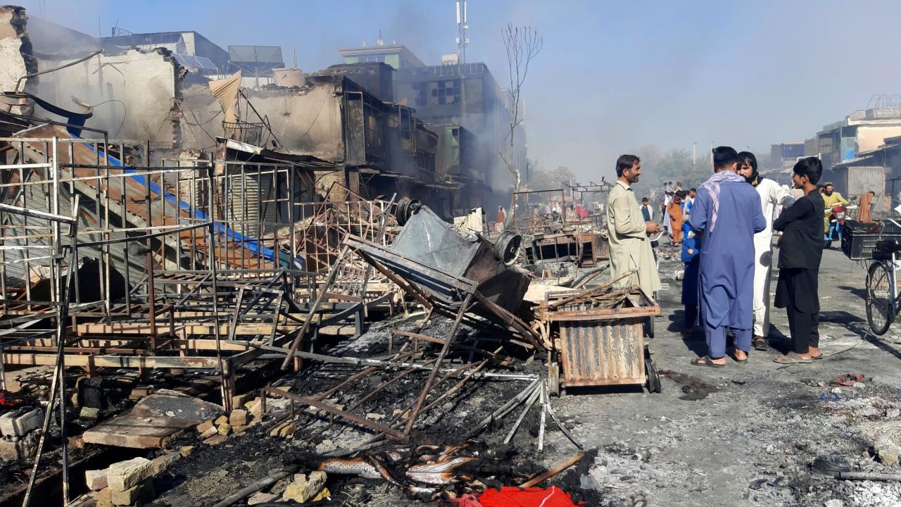 Afghans in Kunduz inspect damaged shops after fighting between Taliban and Afghan security forces on Sunday.