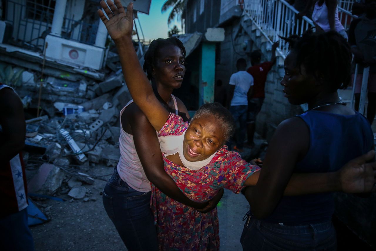 Oxiliene Morency cries out in grief after the body of her 7-year-old-daughter, Esther Daniel, was recovered from the rubble of their home in Les Cayes on Saturday, August 14.