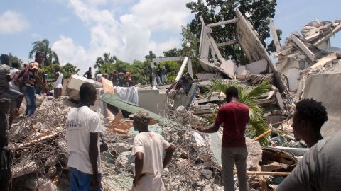 People search through the rubble of what used to be the Manguier Hotel after the earthquake hit on August 14 in Les Cayes, southwest Haiti.