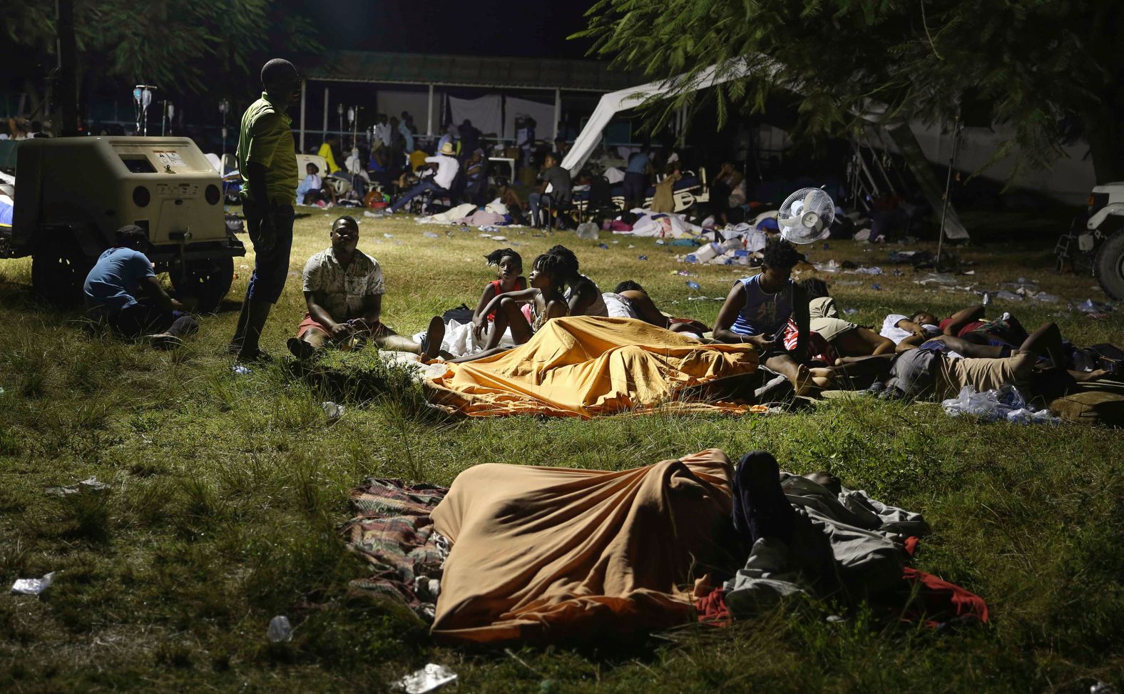 People displaced from their homes spend the night outside a hospital in Les Cayes on August 14.