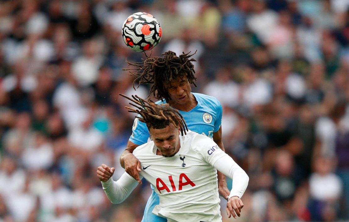 Manchester City's Nathan Ake, top, jumps for the ball with Tottenham's Dele Alli.