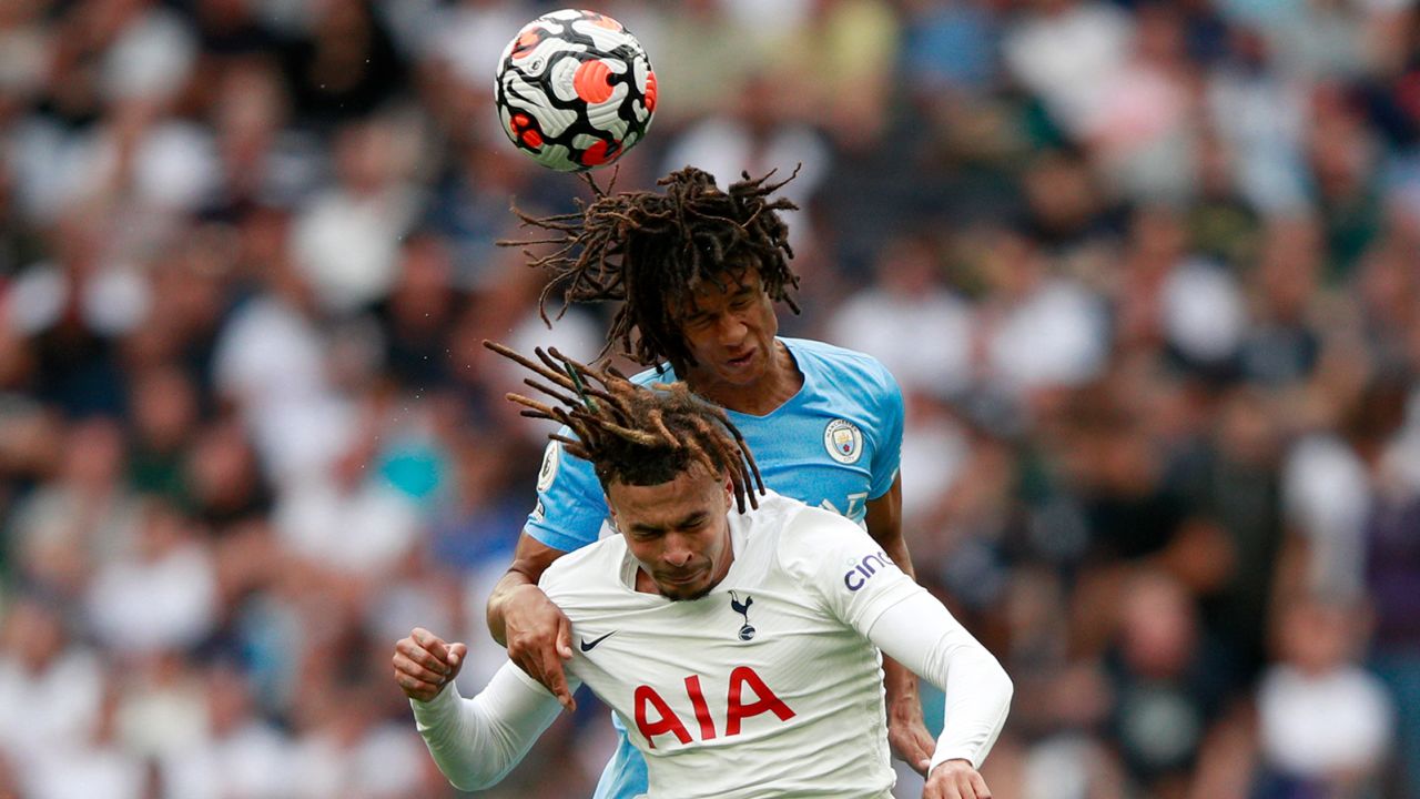 Manchester City's Nathan Ake, top, jumps for the ball with Tottenham's Dele Alli.