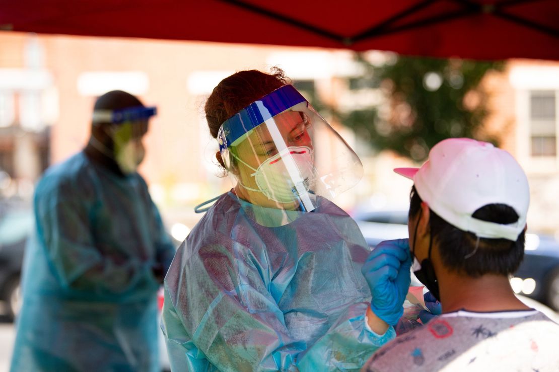 A health care worker administers a Covid-19 test at a testing site in Mifflin Square Park in Philadelphia on Thursday.