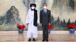 In this photo released by China's Xinhua News Agency, Taliban co-founder Mullah Abdul Ghani Baradar, left, and Chinese Foreign Minister Wang Yi pose for a photo during their meeting in Tianjin, China, Wednesday, July 28, 2021. Wang met with a delegation of high-level Taliban officials as ties between them warm ahead of the U.S. pullout from Afghanistan. (Li Ran/Xinhua via AP)