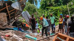 Search for victims in a home destroyed by an earthquake in Camp-Perrin, Les Cayes, Haiti,  Aug. 15, 2021. The death toll from the magnitude 7.2 earthquake in Haiti soared on Sunday.