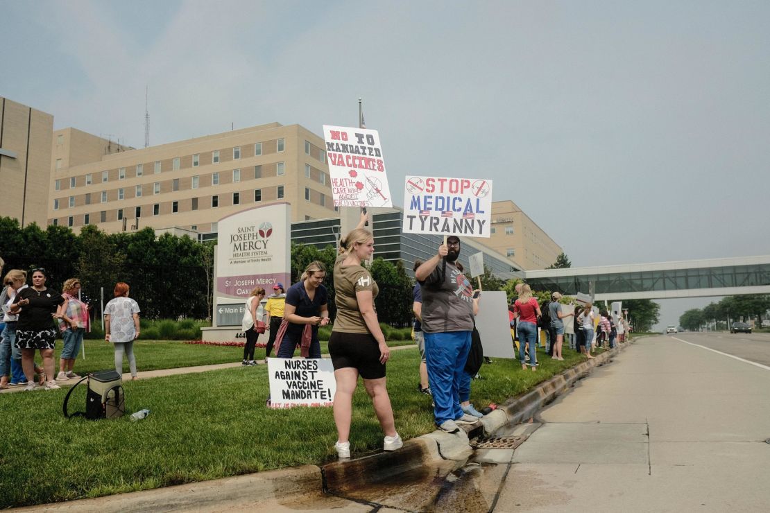 Protesters gather outside St. Joseph Mercy Oakland Hospital in Pontiac, Michigan, on July 24. Health care workers and others gathered at several hospitals throughout Michigan protesting Trinity Health and Henry Ford Health systems' recent requirement that nurses and other health workers  receive a Covid-19 vaccine. 