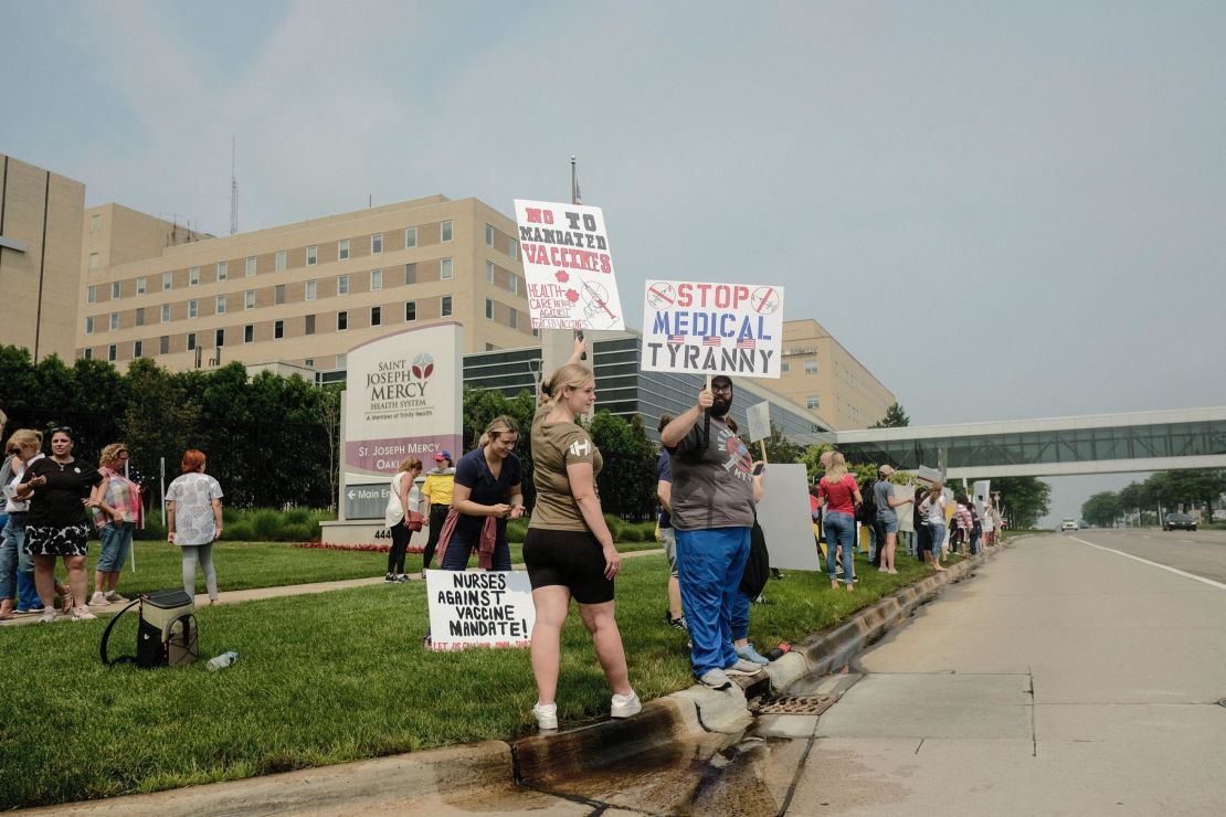 Protesters gather outside St. Joseph Mercy Oakland Hospital in Pontiac, Michigan, on July 24. Health care workers and others gathered at several hospitals throughout Michigan protesting Trinity Health and Henry Ford Health systems' recent requirement that nurses and other health workers receive a Covid-19 vaccine.