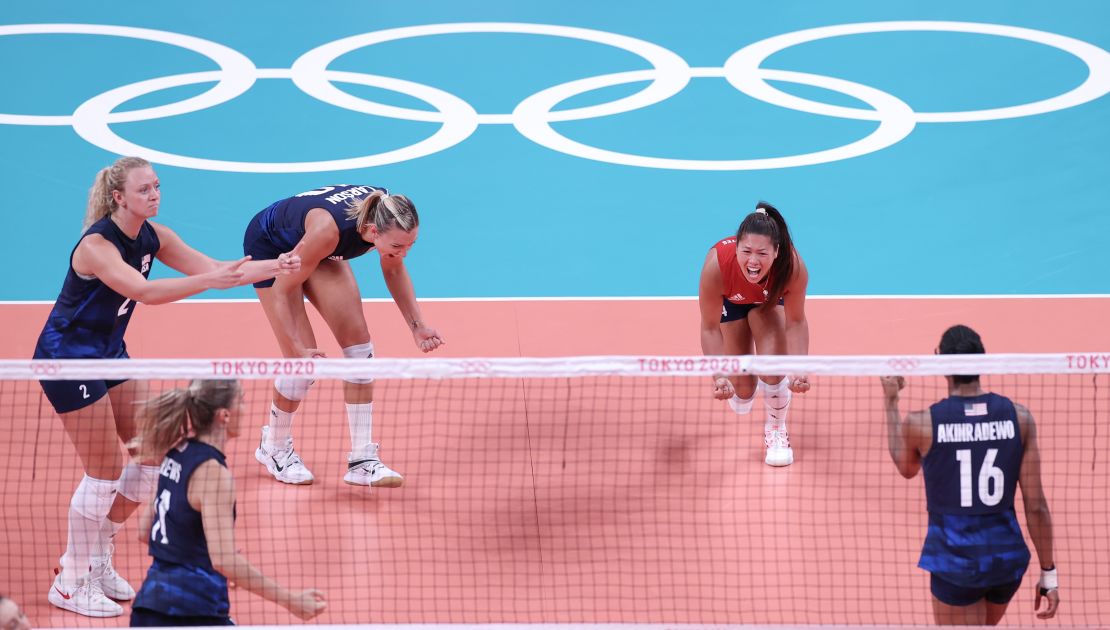 Justine Wong-Orantes (in red) celebrates with teammates during the women's volleyball semifinal between the United States and Serbia on August 6, 2021. 