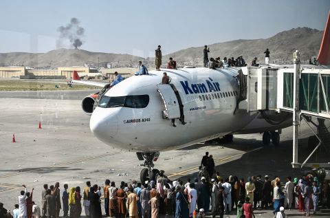 People climb atop a plane at Kabul's international airport after the Taliban retook the capital a day earlier. Hundreds of people<a href="https://www.cnn.com/2021/08/16/middleeast/kabul-afghanistan-withdrawal-taliban-intl/index.html" target="_blank"> </a>poured onto the tarmac, <a href="https://www.cnn.com/2021/08/16/middleeast/kabul-afghanistan-withdrawal-taliban-intl/index.html" target="_blank">desperately seeking a route out of Afghanistan.</a>