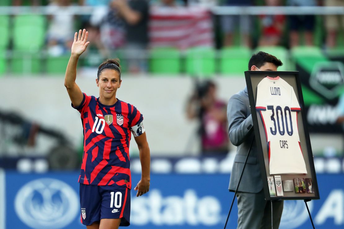 Lloyd greets fans as she receives a recognition of 300 games with her team.