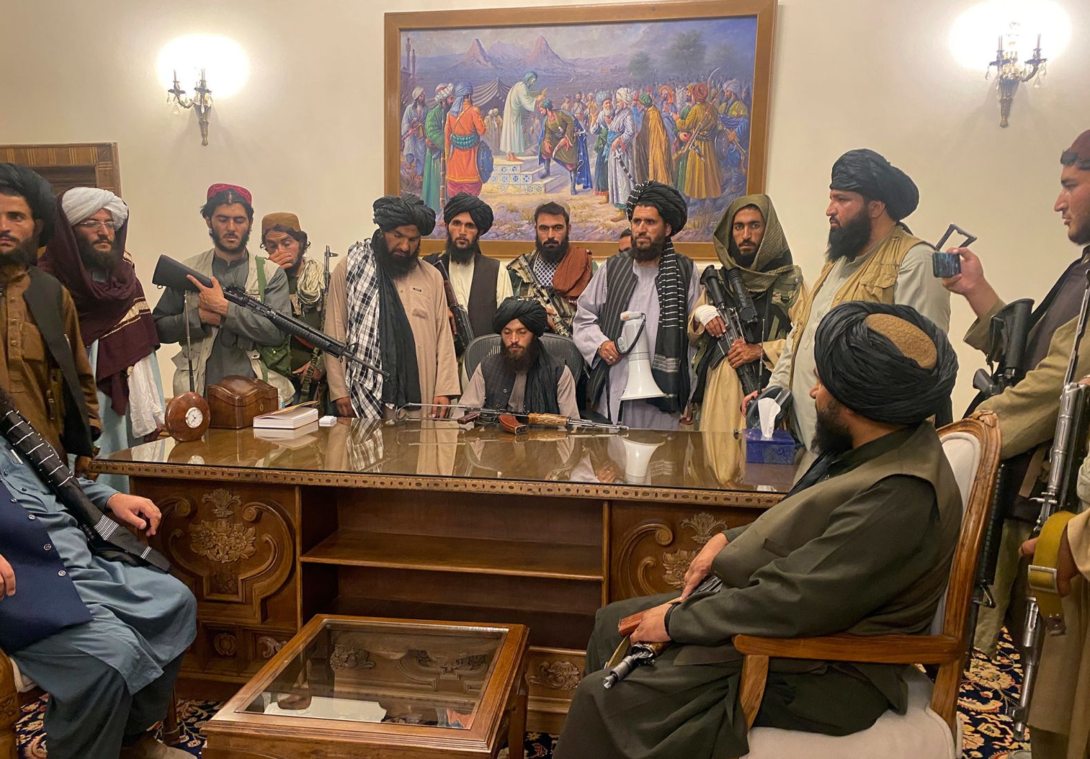Taliban fighters sit inside the presidential palace in Kabul in August 2021. The palace was <a href="index.php?page=&url=https%3A%2F%2Fwww.cnn.com%2F2021%2F08%2F15%2Fpolitics%2Fbiden-administration-taliban-kabul-afghanistan%2Findex.html" target="_blank">handed over to the Taliban</a> after being vacated hours earlier by Afghan government officials. Many of Afghanistan's major cities had already fallen to the insurgent group with little to no resistance.