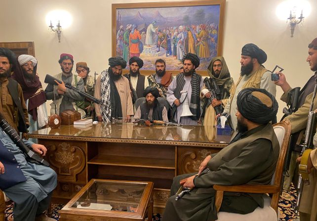 Taliban fighters sit inside the presidential palace in Kabul in August 2021. The palace was <a href="index.php?page=&url=https%3A%2F%2Fwww.cnn.com%2F2021%2F08%2F15%2Fpolitics%2Fbiden-administration-taliban-kabul-afghanistan%2Findex.html" target="_blank">handed over to the Taliban</a> after being vacated hours earlier by Afghan government officials.  Many of Afghanistan's major cities had already fallen to the insurgent group with little to no resistance.