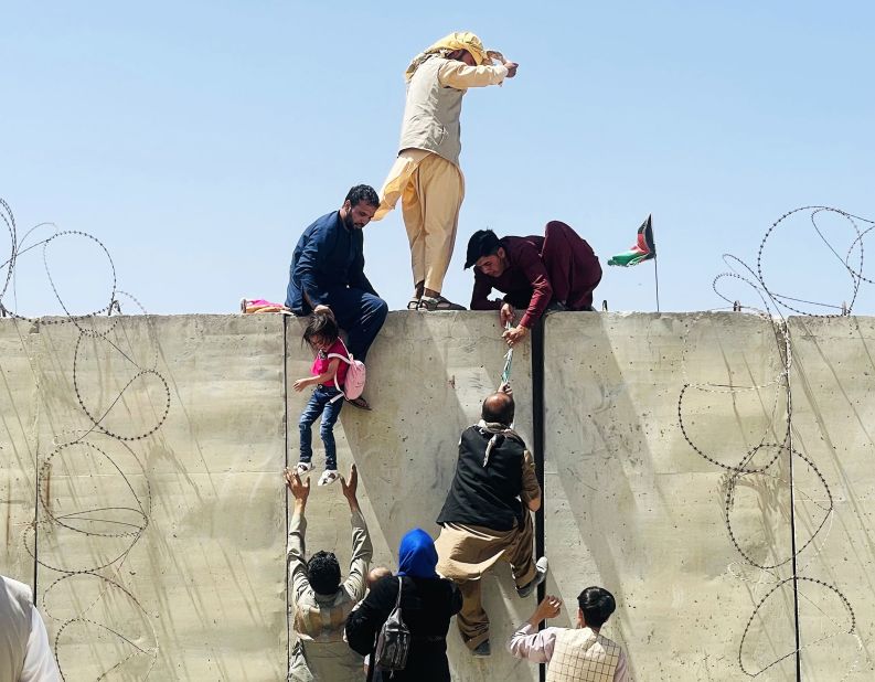 Afghans rush to the airport in Kabul as they try to flee the capital on August 16.