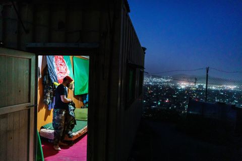 An Afghan soldier, who didn't want to use his name, is seen at an outpost in Kabul on August 15. He looked at the city below and said, "This is like a quick death," referring to the fall of Kabul. He said it was going to be a hard moment for him when he removes his uniform permanently after 10 years of service.