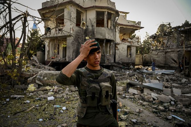 An Afghan security officer stands guard at the site of a car bomb explosion in Kabul on August 4. <a href="index.php?page=&url=https%3A%2F%2Fwww.cnn.com%2F2021%2F08%2F03%2Fmiddleeast%2Ftaliban-afghanistan-us-airstrikes-helmand-herat-intl%2Findex.html" target="_blank">A car bomb exploded near the home of Afghanistan's acting defense minister</a> the day before. In the weeks prior, Kabul had largely been spared from the violence hitting other parts of Afghanistan.