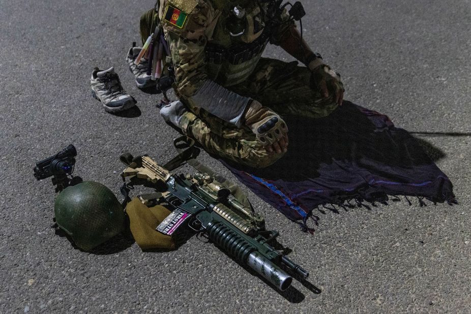 A member of the Afghan Special Forces prays on a highway before a combat mission in Afghanistan's Kandahar province on July 11.