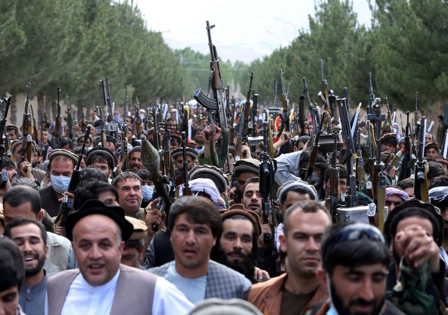 Hundreds of armed men attend a gathering on the outskirts of Kabul on June 23 to announce their support for Afghan security forces and say that they are ready to fight against the Taliban.