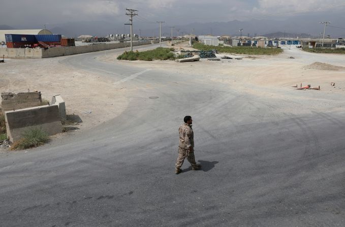 A member of Afghanistan's security forces walks at Bagram Air Base on July 5 after the last American troops <a href="index.php?page=&url=https%3A%2F%2Fwww.cnn.com%2F2021%2F07%2F01%2Fpolitics%2Fus-military-bagram-airfield-afghanistan%2Findex.html" target="_blank">departed the compound.</a> It marked the end of the American presence at a sprawling compound that became the center of military power in Afghanistan.
