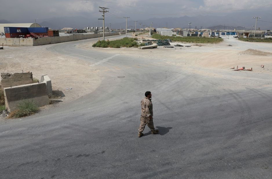 A member of Afghanistan's security forces walks at Bagram Air Base on July 5 after the last American troops <a href="https://www.cnn.com/2021/07/01/politics/us-military-bagram-airfield-afghanistan/index.html" target="_blank">departed the compound.</a> It marked the end of the American presence at a sprawling compound that became the center of military power in Afghanistan.