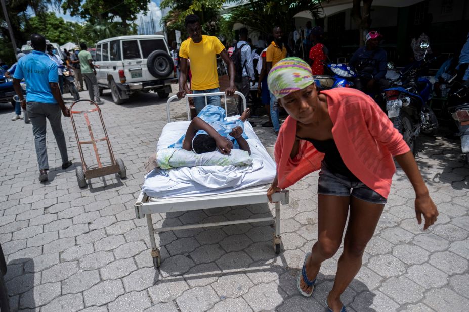 An injured woman is transported to a hospital in Les Cayes on Monday, August 16.