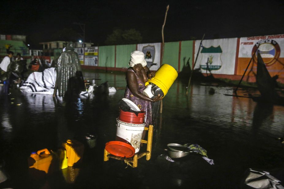 A woman recovers her belongings at a flooded refugee camp. Emergency officials were bracing for heavy rains and floods as <a href="https://www.cnn.com/2021/08/16/americas/haiti-earthquake-news-monday-intl/index.html" target="_blank">Tropical Depression Grace</a> moved toward Haiti.