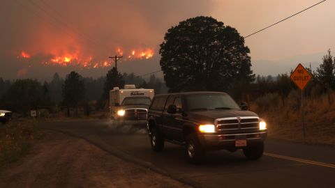 Residents evacuate as the Dixie fire burns into a neighborhood on near Janesville, California.