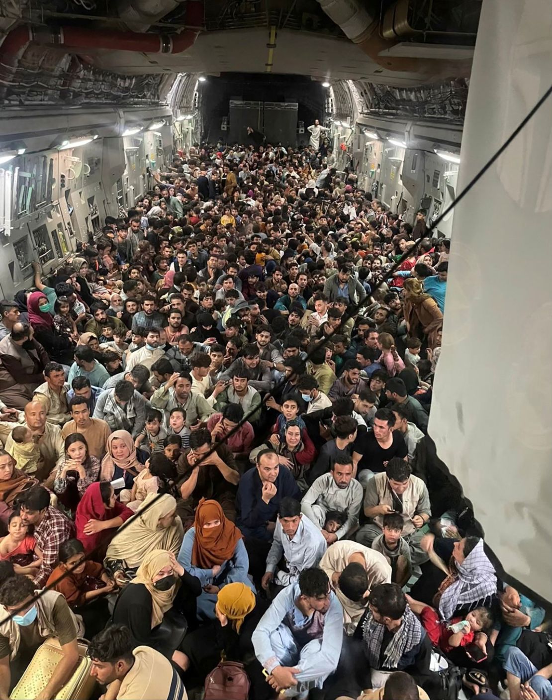 Evacuees crowd the interior of a US Air Force C-17 Globemaster III transport aircraft on a flight to Qatar from Kabul, Afghanistan August 15, 2021. The Air Force said Friday that the plane carried a record 823 people.