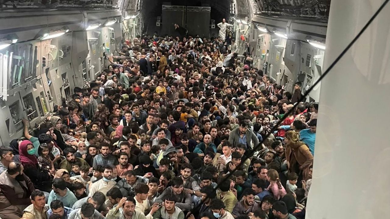 Evacuees crowd the interior of a US Air Force C-17 Globemaster III transport aircraft on a flight to Qatar from Kabul, Afghanistan August 15, 2021. The Air Force said Friday that the plane carried a record 823 people.