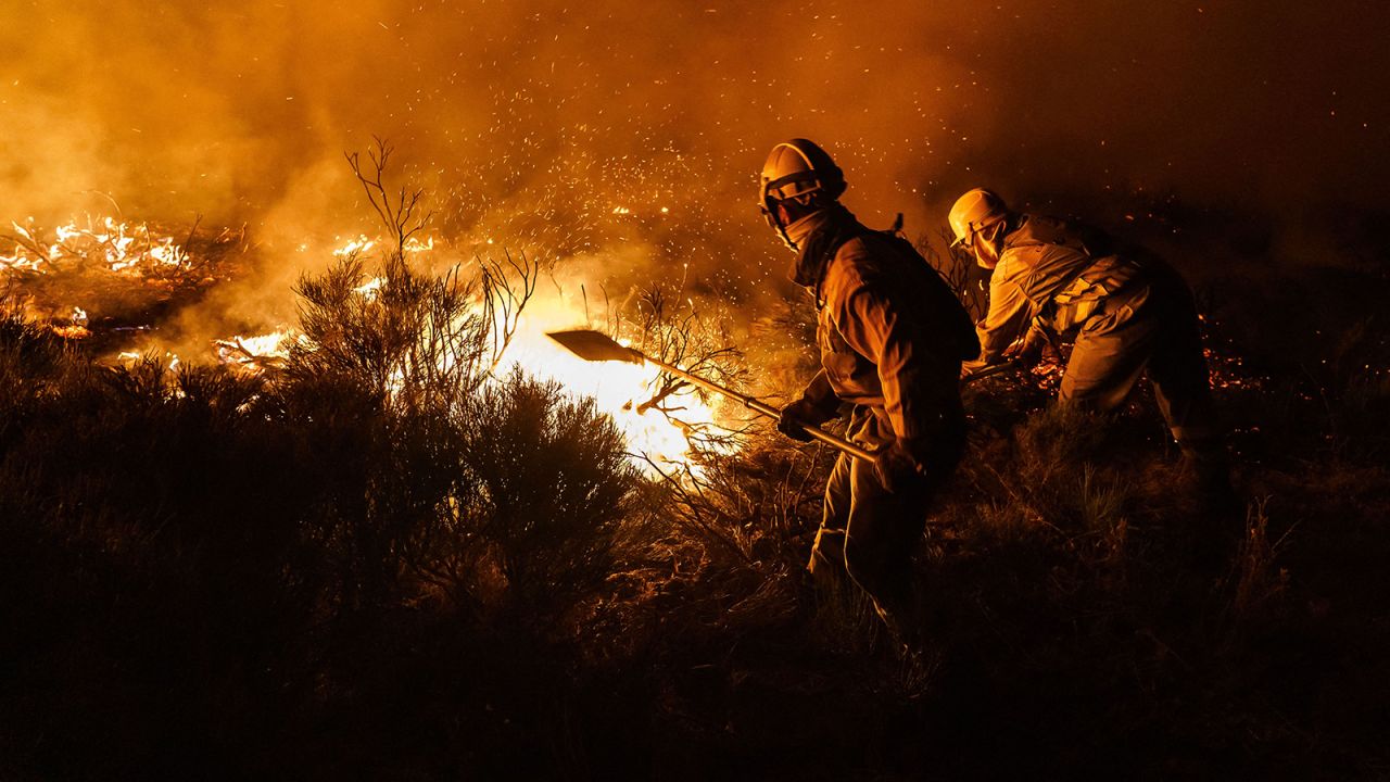 Firefighters battle a wildfire near Avila, Spain, on August 16.