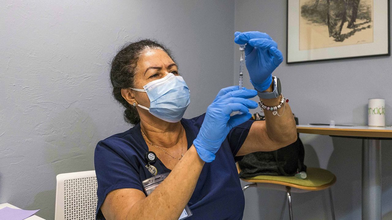 A health care worker prepares a dose of the Pfizer/BioNTech vaccine in Lake Worth, Florida.