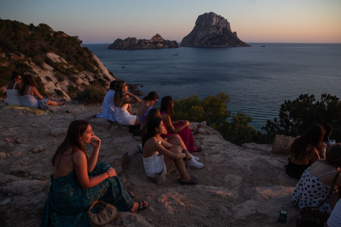 People gather at sunset at the Es Vedra viewpoint on July 16, 2021.