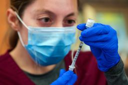 Alma Sevilla preparers a Pfizer vaccine vial at a mobile vaccine clinic in Los Angeles.