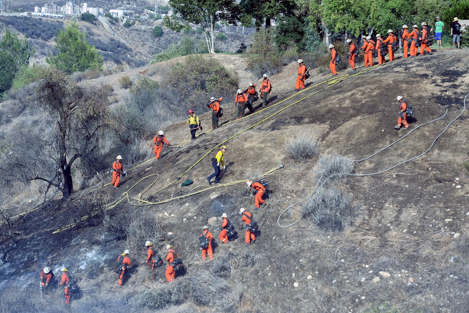 Crews battle a fire in Newhall, California, on August 12.