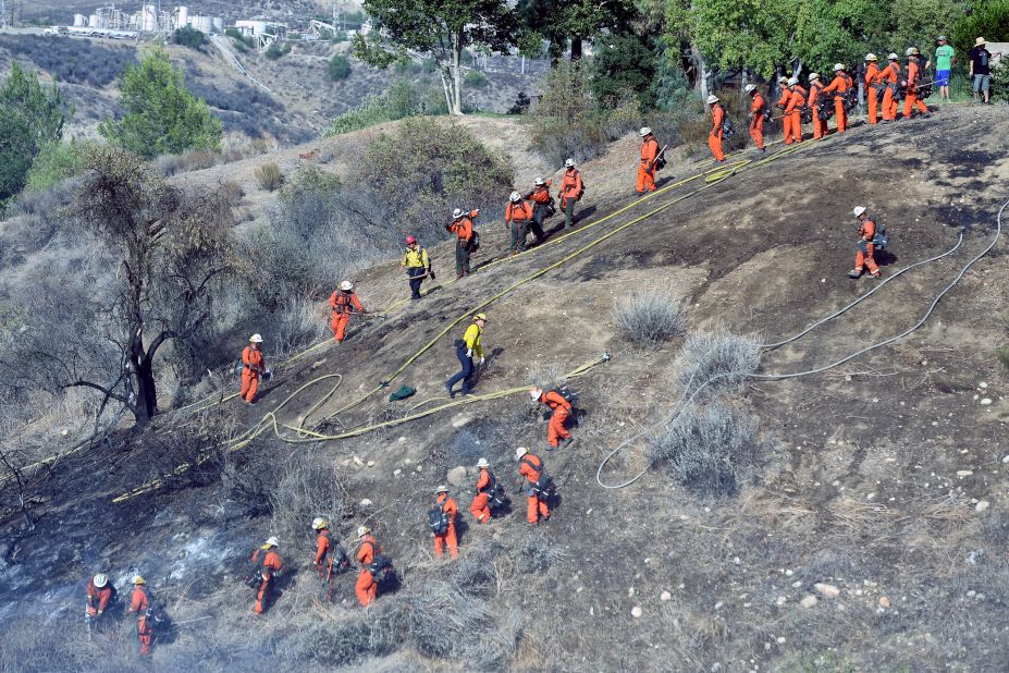 Crews battle a fire in Newhall, California, on August 12.