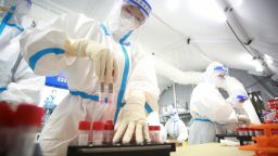 Medical workers wearing personal protective equipment (PPE) work on samples from local residents to be tested for COVID-19 at an air-inflated mobile COVID-19 test lab, known as the 'Falcon labs', on August 17, 2021 in Yangzhou, Jiangsu Province of China.