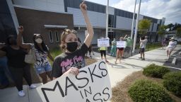 Pro-mask wearing parents stage a protest at the Cobb County School Board headquarters, on Aug. 12, 2021, in Marietta, Ga. 