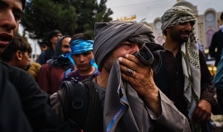 A man reacts as he watches Taliban fighters use violence to control a crowd outside the airport on August 17. At least a dozen people were wounded in the incident, <a href="index.php?page=&url=https%3A%2F%2Fwww.latimes.com%2Fworld-nation%2Fstory%2F2021-08-17%2Fsnapshot-of-suffering-afghans-trying-to-reach-airport-are-penned-up-beaten-by-taliban" target="_blank" target="_blank">according to the Los Angeles Times.</a>
