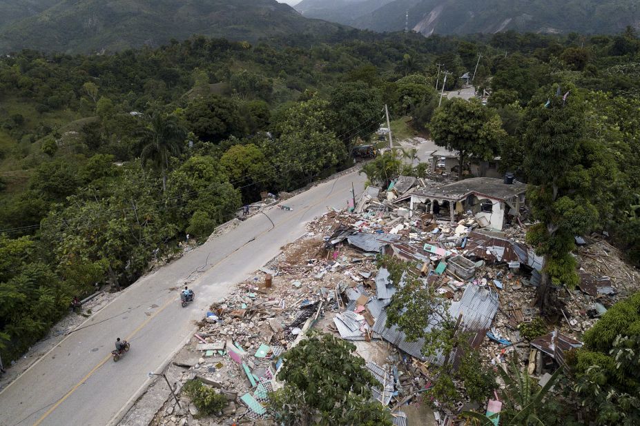 Severely damaged homes are seen along a road in Rampe, Haiti, on August 18.