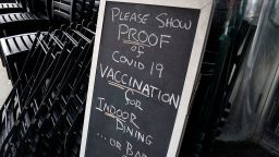 A sign is viewed at a restaurant in New York's Upper West Side on August 17, 2021, the first day where you have to show proof of having a Covid-19 vaccination to participate in indoor dining. The vaccine mandate also includes indoor gyms, and all indoor entertainment in New York City. 
