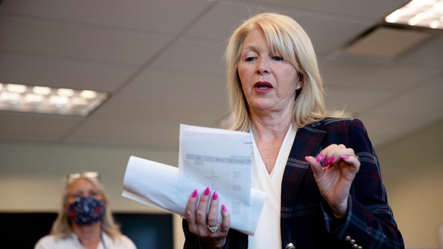 In this Tuesday, June 30, 2020 photo, Mesa County Clerk Tina Peters reads an update on the election in Grand Junction, Colo. 