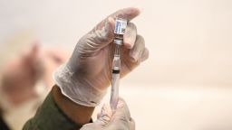A healthcare worker prepares a syringe with a vial of the J&J/Janssen Covid-19 vaccine at a temporary vaccination site at Grand Central Terminal train station on May 12, 202 in New York City. 