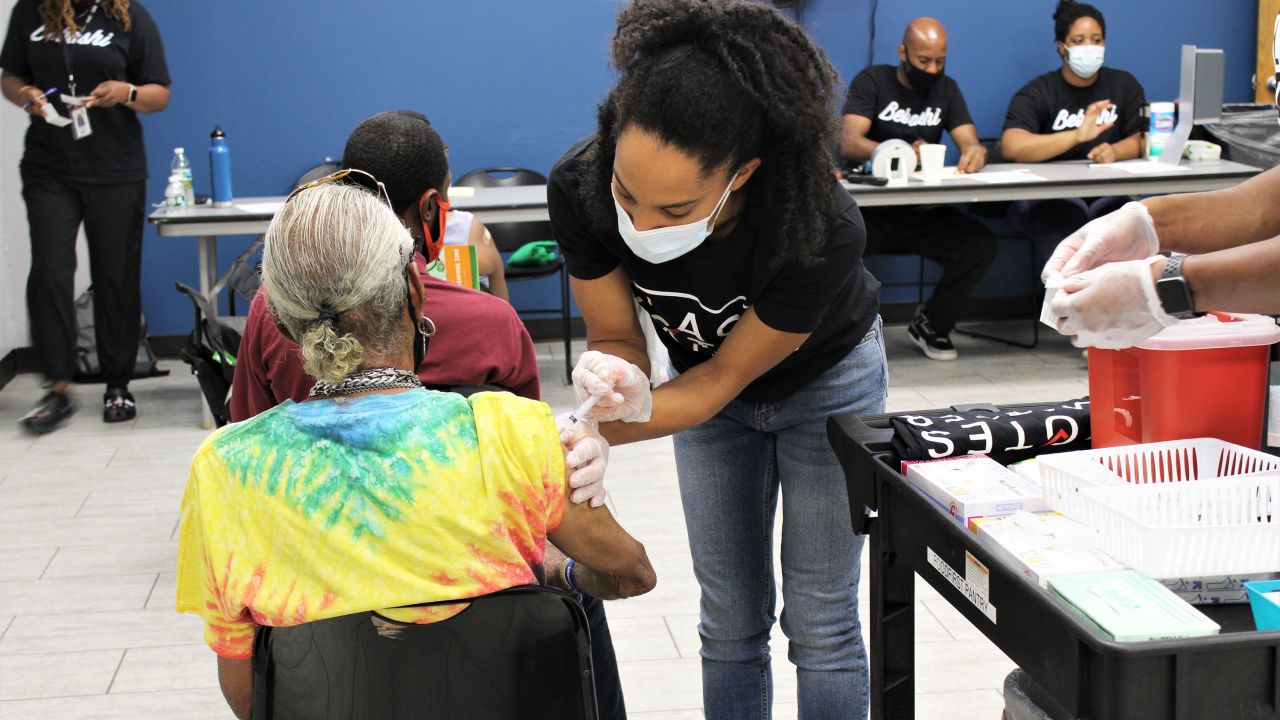 A Temple University medical student volunteer administers the first dose of the Moderna vaccine.