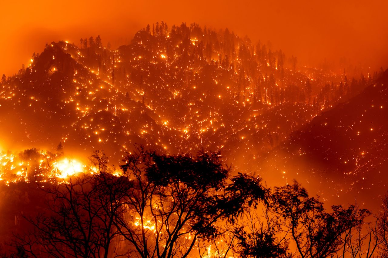In this long-exposure photo, embers light up hillsides as the Dixie Fire burns near Milford, California, on August 17.
